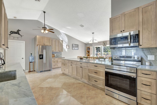 kitchen with decorative backsplash, light brown cabinetry, stainless steel appliances, and lofted ceiling