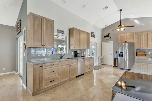 kitchen with appliances with stainless steel finishes, tasteful backsplash, ceiling fan, sink, and high vaulted ceiling