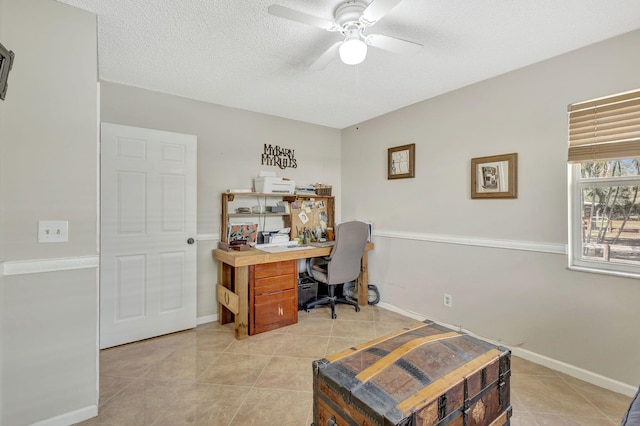 tiled office featuring ceiling fan and a textured ceiling