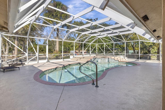 view of swimming pool featuring an in ground hot tub, glass enclosure, and a patio area