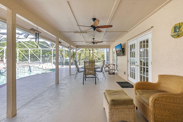 view of patio with french doors, ceiling fan, and a lanai