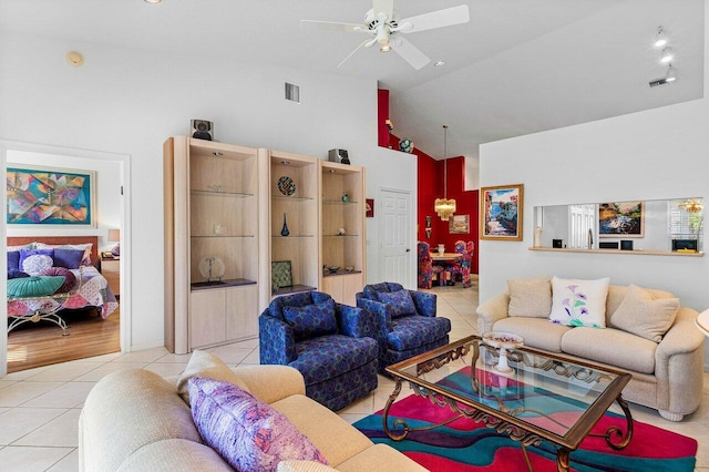 tiled living room with high vaulted ceiling and ceiling fan