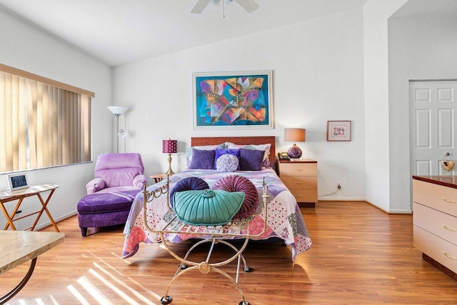 bedroom with vaulted ceiling, ceiling fan, and light hardwood / wood-style flooring