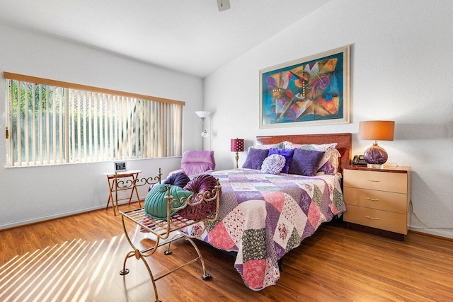 bedroom featuring vaulted ceiling and hardwood / wood-style floors