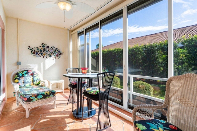 sunroom / solarium featuring ceiling fan