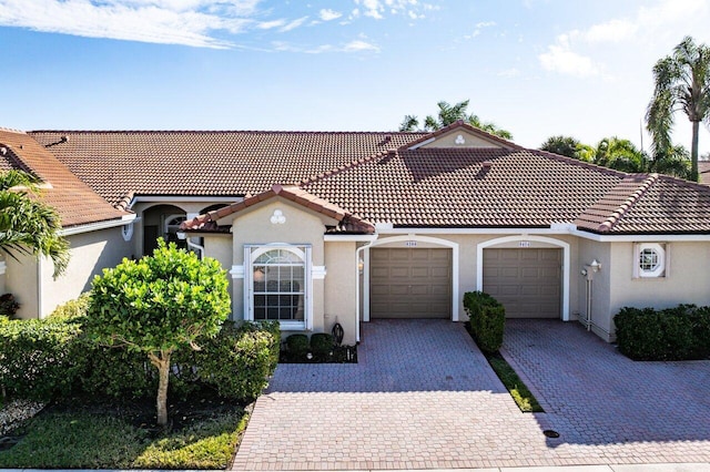 mediterranean / spanish house featuring a garage