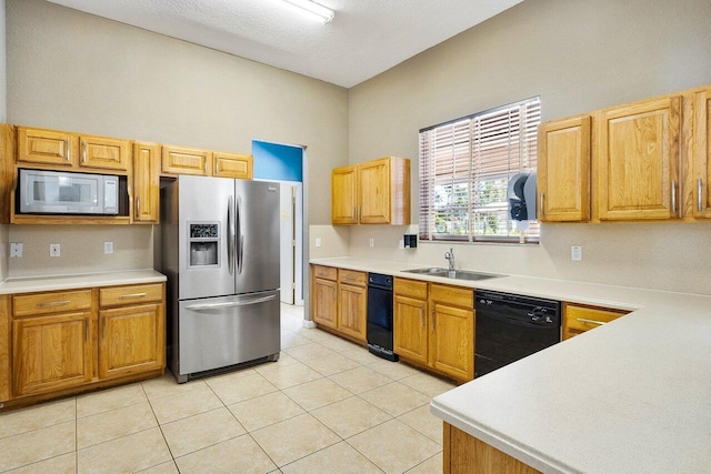 kitchen with light tile patterned floors, sink, stainless steel refrigerator with ice dispenser, built in microwave, and dishwasher