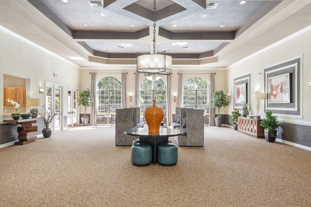 carpeted dining room with a raised ceiling, crown molding, a high ceiling, and french doors