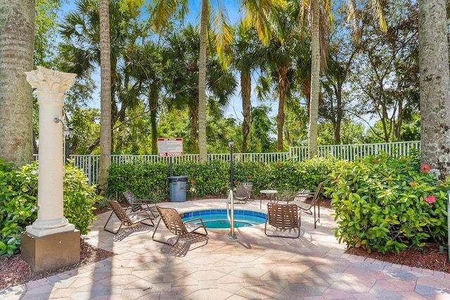 view of pool featuring a patio and a community hot tub