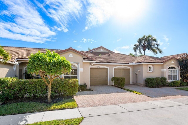 mediterranean / spanish-style house with a garage