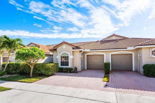 mediterranean / spanish-style home featuring a garage