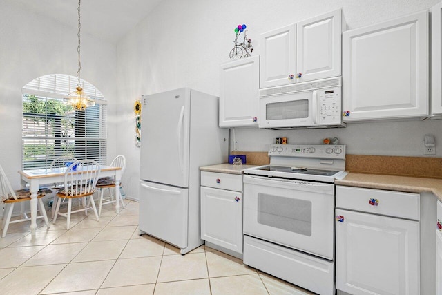 kitchen with white appliances, a chandelier, light tile patterned floors, white cabinetry, and hanging light fixtures