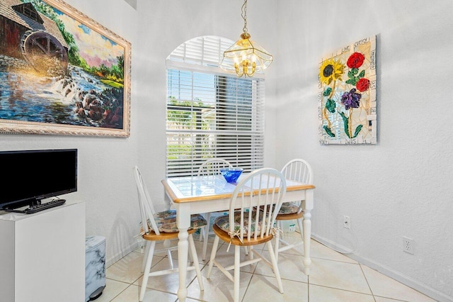 tiled dining space featuring an inviting chandelier