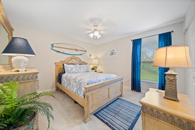 bedroom with ceiling fan and light carpet