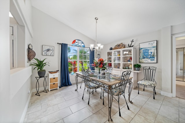 dining room featuring lofted ceiling, light tile patterned floors, and a chandelier