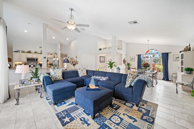 tiled living room featuring high vaulted ceiling and ceiling fan