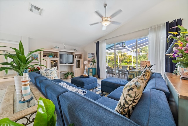 living room featuring ceiling fan and lofted ceiling