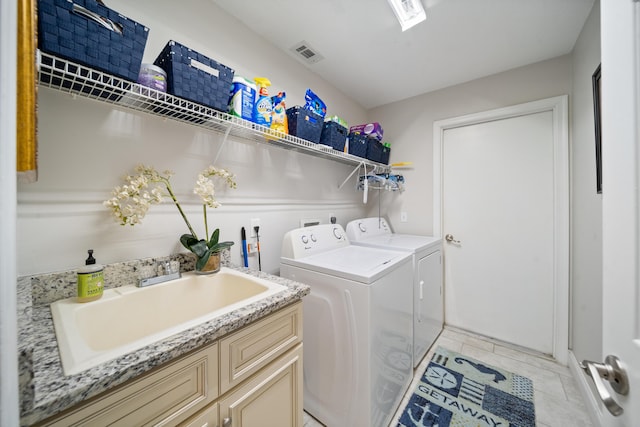 laundry room featuring sink, light tile patterned floors, and independent washer and dryer