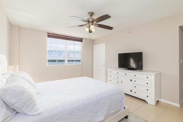 1801 N Flagler Dr Unit 840, West Palm Beach, FL 33407 - bedroom featuring light tile patterned floors, baseboards, and ceiling fan