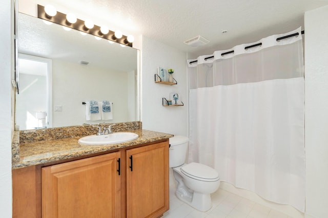 1801 N Flagler Dr Unit 840, West Palm Beach, FL 33407 - full bathroom featuring vanity, toilet, tile patterned flooring, a shower with shower curtain, and a textured ceiling