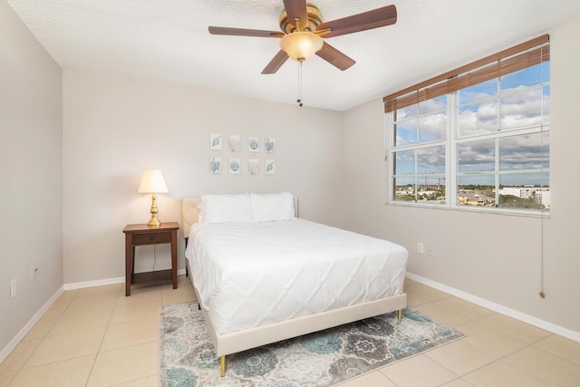 1801 N Flagler Dr Unit 840, West Palm Beach, FL 33407 - bedroom with light tile patterned floors, baseboards, ceiling fan, and a textured ceiling