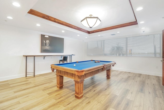 game room featuring light wood-type flooring, billiards, and a tray ceiling