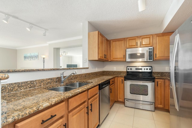 1801 N Flagler Dr Unit 840, West Palm Beach, FL 33407 - kitchen featuring stainless steel appliances, a sink, track lighting, a textured ceiling, and ornamental molding