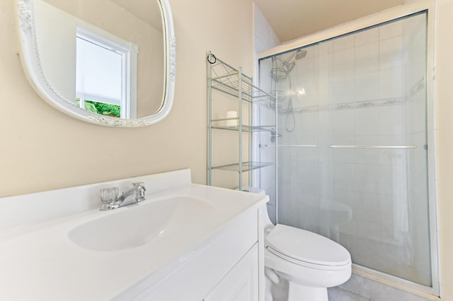 bathroom with walk in shower, vanity, and toilet