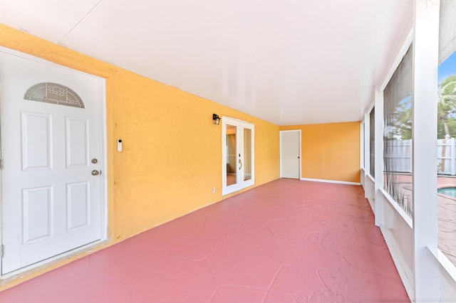 unfurnished sunroom featuring french doors