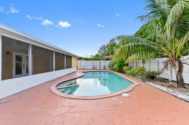 view of pool with a patio area and a sunroom