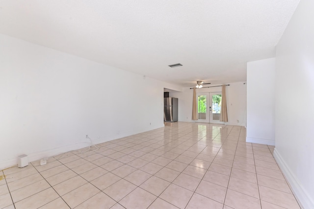 tiled spare room with french doors and ceiling fan