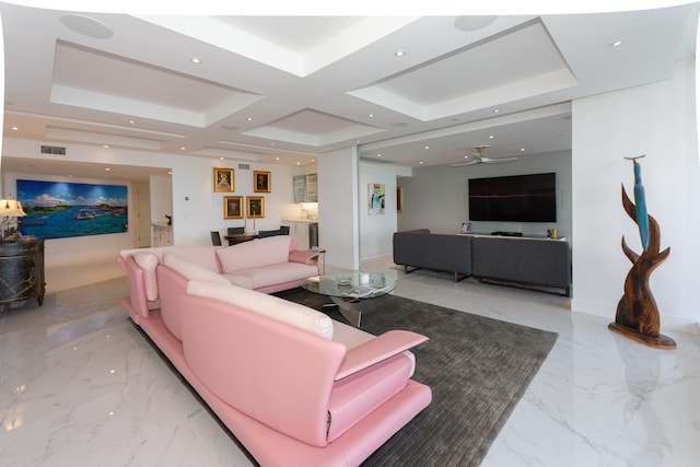 living room featuring ceiling fan and coffered ceiling