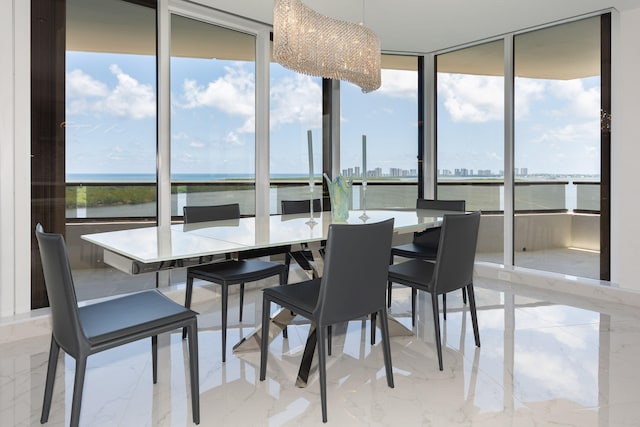 dining room featuring a water view, a wealth of natural light, and a wall of windows