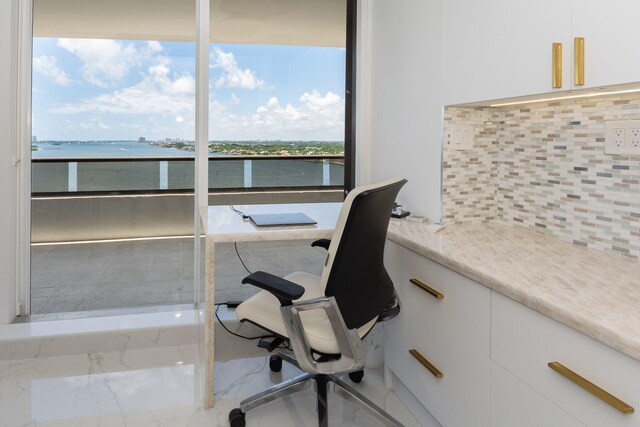 office space featuring a water view