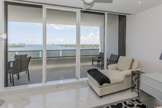 living area featuring floor to ceiling windows and a water view