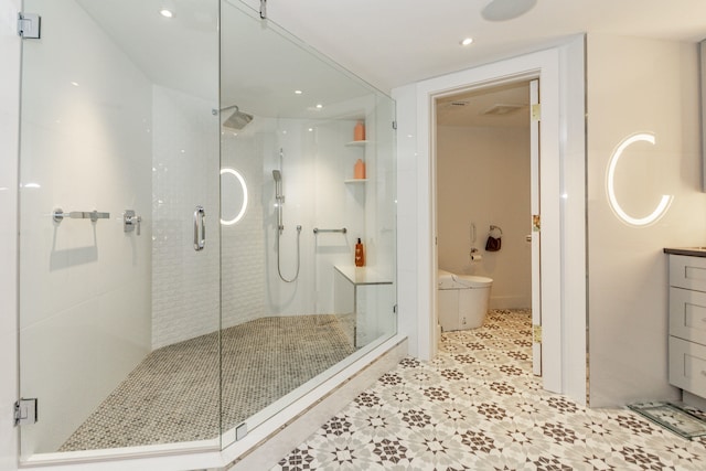 bathroom with vanity, an enclosed shower, and toilet