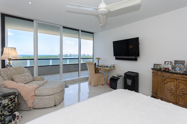 bedroom featuring expansive windows, access to outside, and ceiling fan