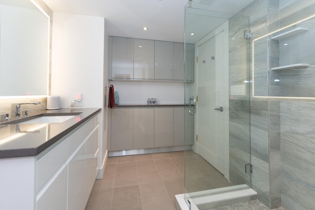 bathroom featuring an enclosed shower, vanity, and tile patterned floors