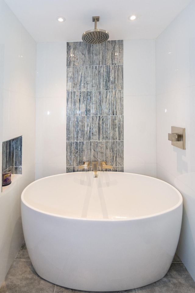 bathroom featuring separate shower and tub and tile walls