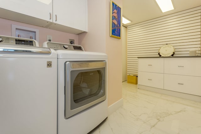 washroom with cabinets and separate washer and dryer