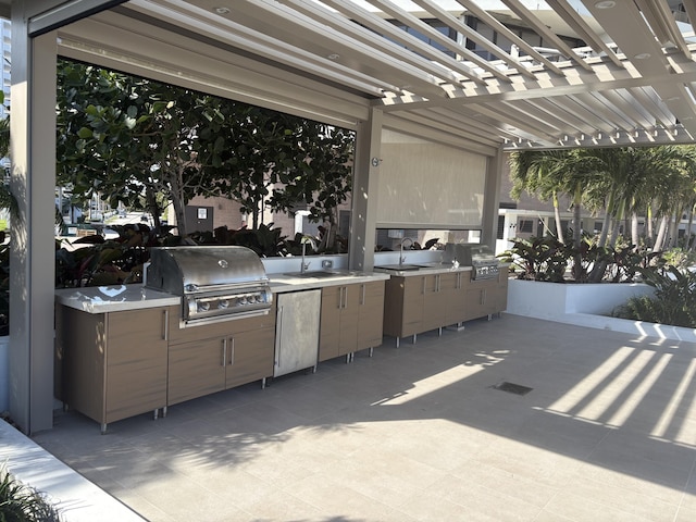 view of patio / terrace featuring an outdoor kitchen, area for grilling, sink, and a pergola