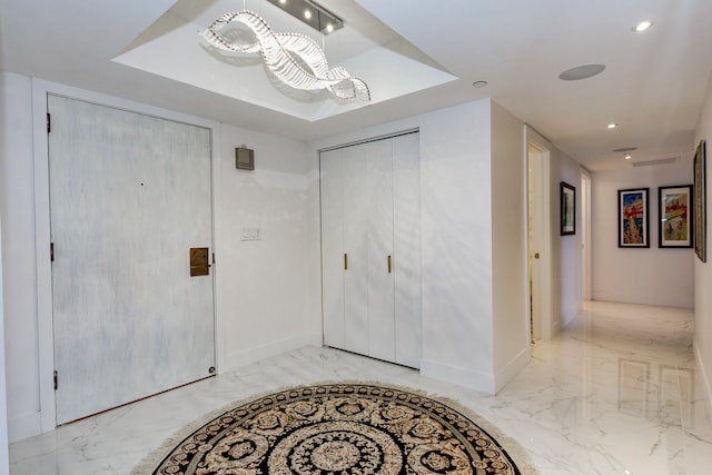 foyer with a raised ceiling