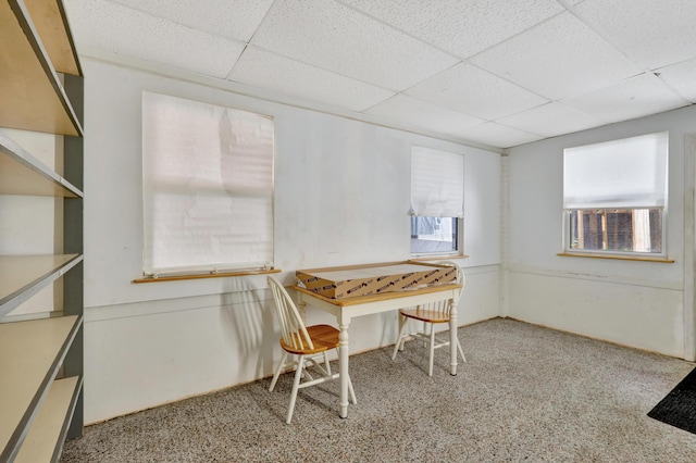 dining room featuring a drop ceiling and plenty of natural light