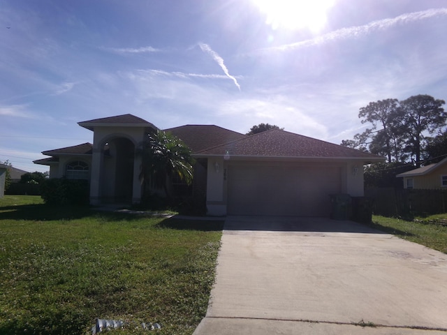 view of front facade with a garage and a front lawn