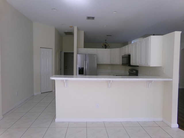 kitchen featuring a breakfast bar, kitchen peninsula, stainless steel fridge with ice dispenser, black / electric stove, and white cabinetry