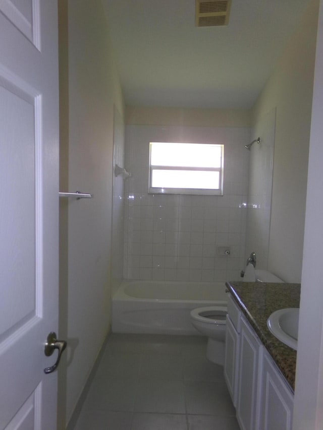 full bathroom with tile patterned flooring, vanity, toilet, and tiled shower / bath