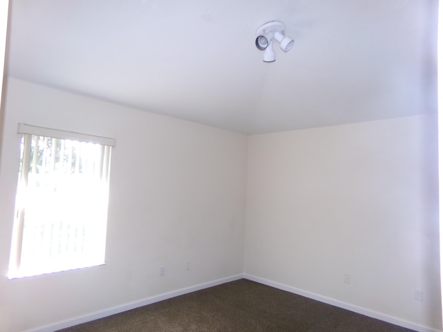 empty room featuring dark colored carpet