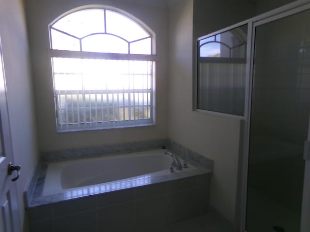 bathroom featuring plus walk in shower