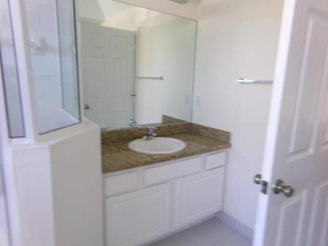 bathroom with tile patterned floors and vanity