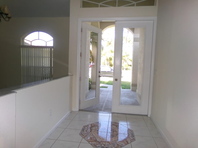 doorway to outside with light tile patterned floors, a wealth of natural light, and french doors